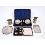 A group of silver comprising: a cased set of two silver butter dishes with knives, Sheffield,