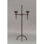 A cast iron pricket stick, 20th century, with two candle holders, on curved tripod legs, 78cm