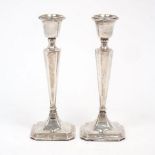 A pair of George V silver candlesticks, Chester, 1913, Clark & Sewell, the tapering squared stems to