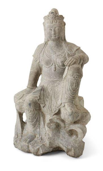 A large Chinese Tang-style carved stone figure of Guanyin, late Qing dynasty, depicted seated on a