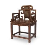 A Chinese hardwood armchair, Qing dynasty, Qianlong period, with carved panels to back and shaped