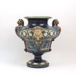 A Continental majolica urn, 19th century, of blue-brown slip glaze with green and yellow highlights,