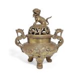 A Chinese polished bronze 'temple lion' tripod censer and cover, early 20th century, of compressed