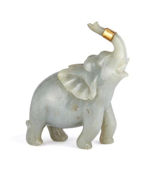 A Chinese jadeite figure of an elephant, early 20th century, carved with its head tilted back and