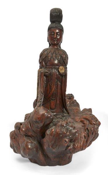 A Chinese gilt-painted rootwood carving of Guanyin, 20th century, carved standing atop a large