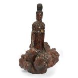 A Chinese gilt-painted rootwood carving of Guanyin, 20th century, carved standing atop a large