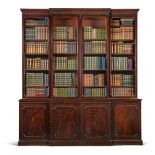 A George III mahogany breakfront bookcase, late 18th century, the fluted cornice above four glazed