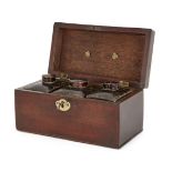 A George III mahogany tea caddy, late 18th century, with brass carrying handle, the interior with
