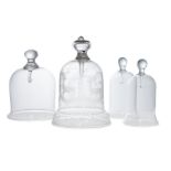 Four glass pocket watch display domes, late 19th century and later, comprising: an engraved bell