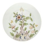 A Liverpool delft plate, c.1760, painted in the Fazackerley palette with flowers and rockwork, 22.