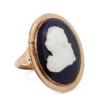A George III cameo gold ring, c.1790, depicting the profile of a gentleman, on blue enamel, ring