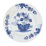 An English delft blue and white plate, probably Liverpool, mid-18th century, decorated with flowers,