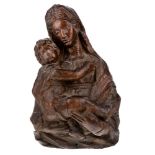 An Italian carved walnut bust length relief of the Madonna and child, 16th century, 36cm high,