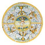 An Italian maiolica alzata, early 17th century, probably Deruta, painted with Cupid in a landscape