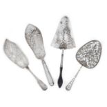 Four pierced Georgian silver fish slices, comprising: a George II example with wooden handle,