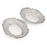 A pair of late Victorian repousse silver dishes, London, 1890, William Comyns & Sons, of shaped oval