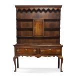 A George III oak dresser, Circa 1790, the superstructure with top shelf above central cupboard door,