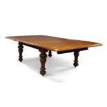A Victorian mahogany extending dining table, circa 1860, on carved inverted baluster legs, with