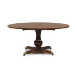 A Regency rosewood tilt top breakfast table, the oval top with brass inlay, raised on octagonal