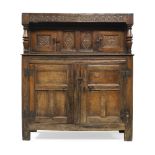 An oak Court Cupboard, 17th century and later, the top frieze carved MLA:MK:1682', above two central