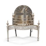 A George III style cast iron and steel fire grate, the arch back with beaded fan design,