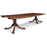 An early Victorian mahogany twin pedestal dining table, the rounded rectangular top with one