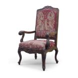 A French walnut framed scroll armchair, early 19th century, with tapestry upholstery seat and back