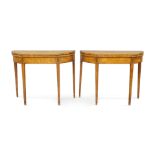 A pair of George III satinwood D shaped card tables, late 18th century, the tops crossbanded and