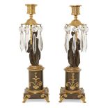 A pair of Regency gilt and patinated bronze Chinoiserie style candlesticks, c.1810, the nozzles