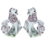 A pair of French faience armorial lions, probably 19th century, manganese M marks, each seated on