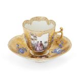 A Meissen gold-ground quatrefoil coffee cup and saucer, c.1755-65, the cup with blue crossed