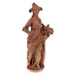 A French terracotta model of a lady, 19th century, modelled in oriental costume holding a bird and