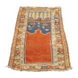 A Ladik prayer rug, Central Anatolia, late 18th century, the plain red mihrab surrounded by