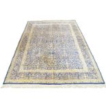 A Kirman Carpet, south east Persian, circa 1950, with repeating vase of flower motifs, on a cobalt