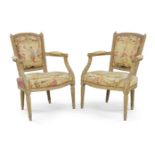 A pair of French fauteuil, late 19th century, with stud bound tapestry upholstery, reeded frame,