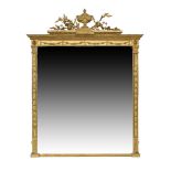 An early Victorian giltwood over mantle mirror, the carved urn crest with swags beside foliage,