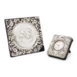 An Edwardian silver mounted photo frame with putti-decorated cover, London, 1902, William Comyns &