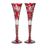 A pair of Bohemian ruby and etched trumpet vases, early 20th century, each decorated with stags on a