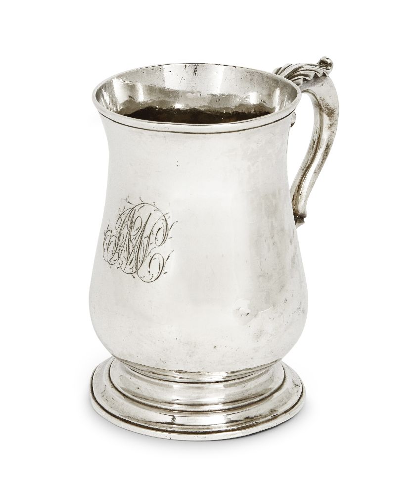 A George III silver mug, London, 1767, John King, of baluster form, the scroll handle with foliate