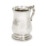 A George III silver mug, London, 1767, John King, of baluster form, the scroll handle with foliate