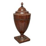 A Georgian urn-shaped mahogany knife/spoon box, line inlaid, the lid with acorn finial supported