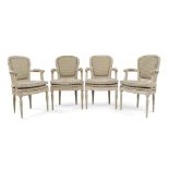 A set of four Louis XVI style fauteuil, the carved frames painted grey, raised on fluted supports