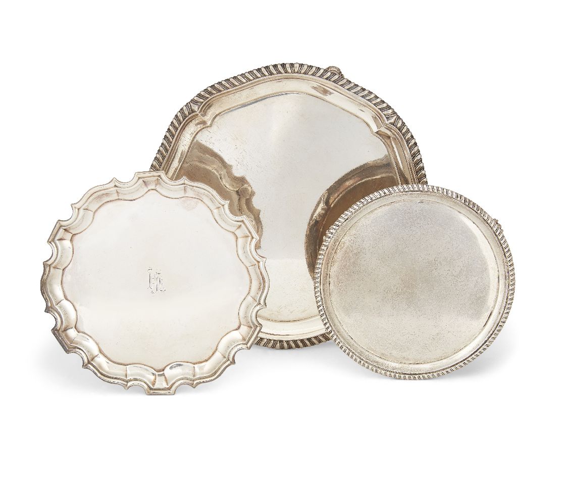 Two 18th century silver waiters, one designed with piecrust edge and raised on thee pad feet,