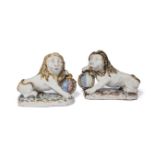 A pair of Continental faience armorial lion candlesticks, 19th century, each seated on their