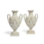 A pair of Derby white biscuit porcelain two-handled vases, c.1785-95, incised crowned crossed