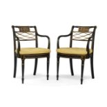 A pair of Regency ebonised armchairs, circa 1810, in the manner of John Gee, the top rail with a