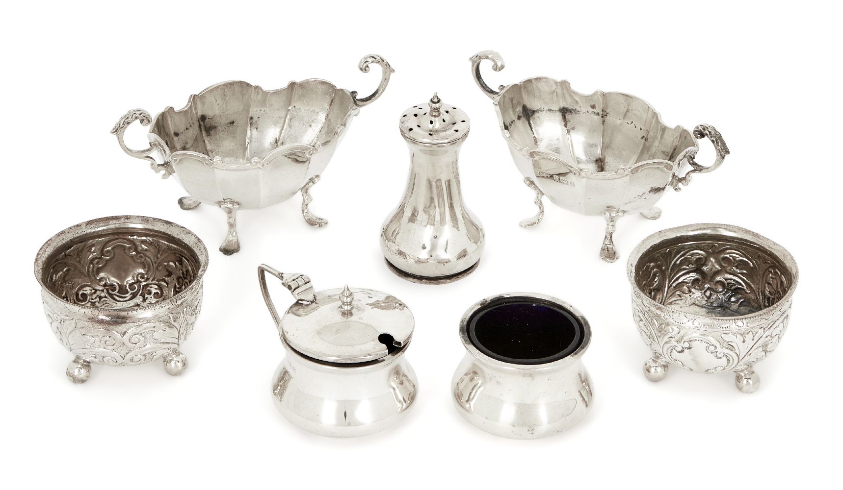 A pair of Victorian silver salt cellars, London, 1890, Horace Woodward & Co., both with repousse