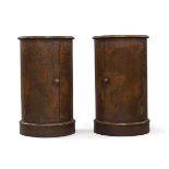 A pair of Victorian burr walnut cylindrical pot cupboards, with single doors, raised on plinth