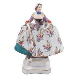 A Dresden porcelain figure of The Lady of the Mopsorden, a member of 'The Order of the Pug', 19th