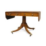 A Regency rosewood pedestal sofa table, the drop leaves with canted corners and boxwood stringing,